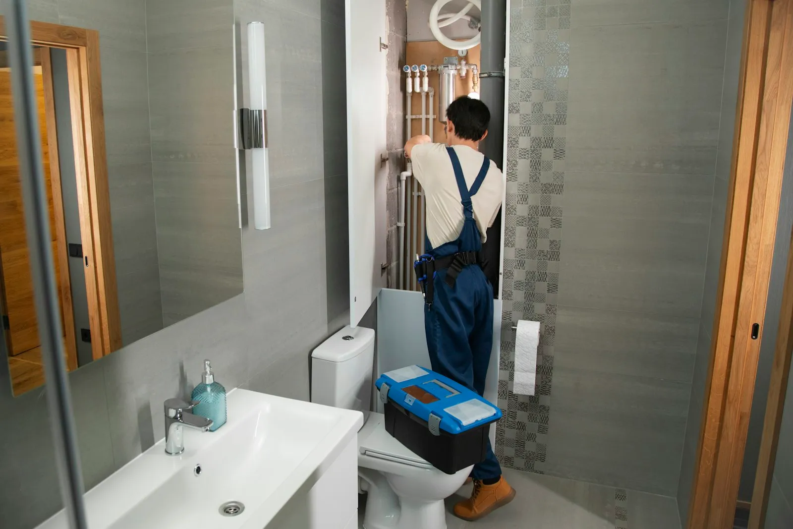 A Plumbing by Bishop technician at work in a clean Treasure Coast home